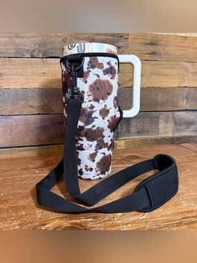 Drink Handlers 40oz Sleeve Western Cow Print With Strap (cup not included).